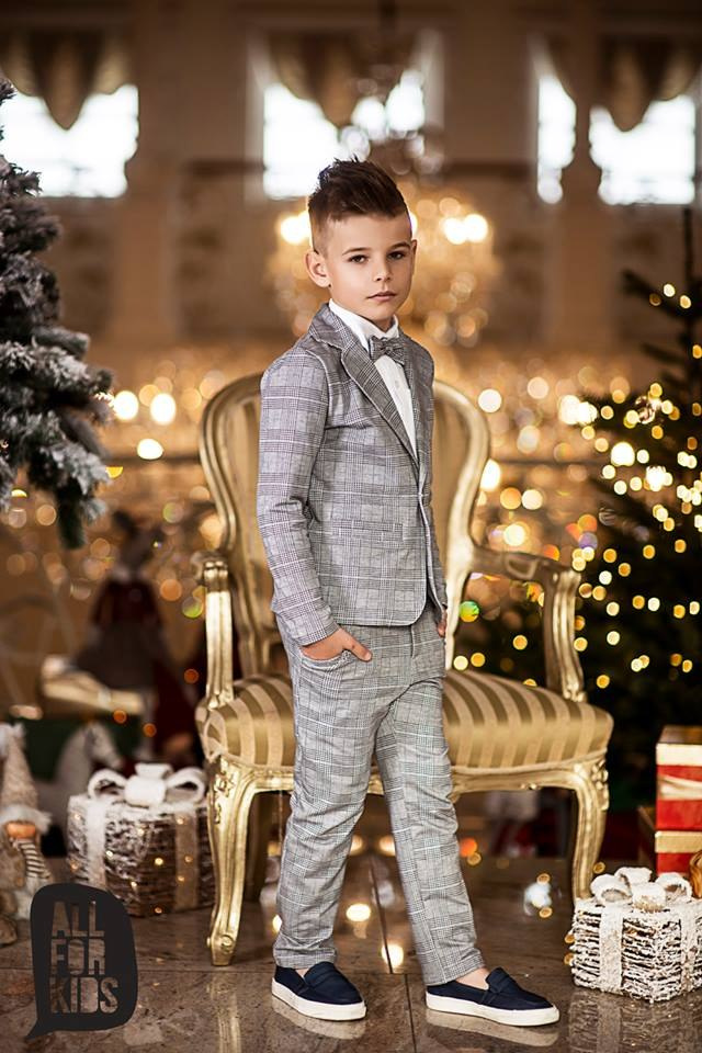Sports an elegant suit with a black bow tie, plaid Sports an elegant suit with a black bow tie, plaid