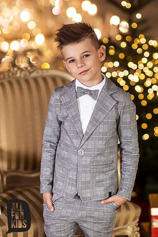 Sports an elegant suit with a black bow tie, plaid Sports an elegant suit with a black bow tie, plaid