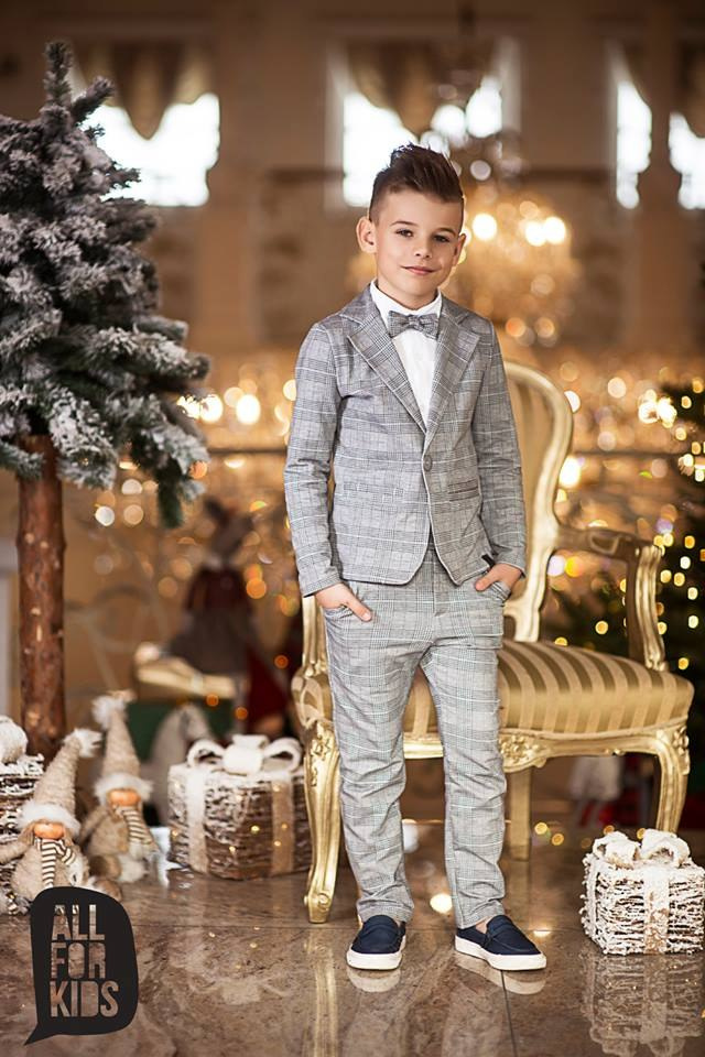 Sports an elegant suit with a black bow tie, plaid Sports an elegant suit with a black bow tie, plaid