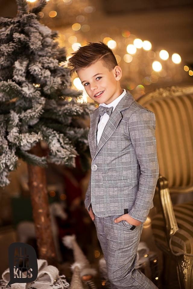 Sports an elegant suit with a black bow tie, plaid Sports an elegant suit with a black bow tie, plaid