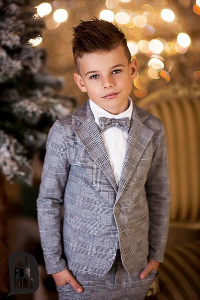 Sports an elegant suit with a black bow tie, plaid Sports an elegant suit with a black bow tie, plaid