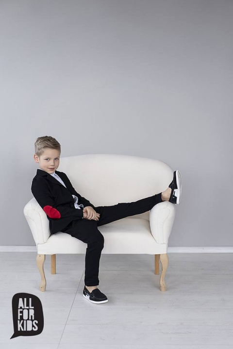 Elegantly sporty black suit with bow tie and red patches Elegantly sporty black suit with bow tie and red patches