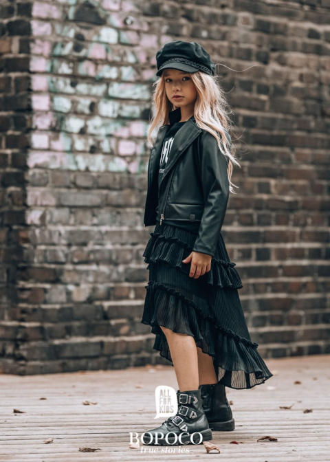 Pleated skirt with flounces and an extended back Pleated skirt with flounces and an extended back