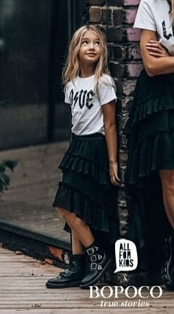 Pleated skirt with flounces and an extended back Pleated skirt with flounces and an extended back