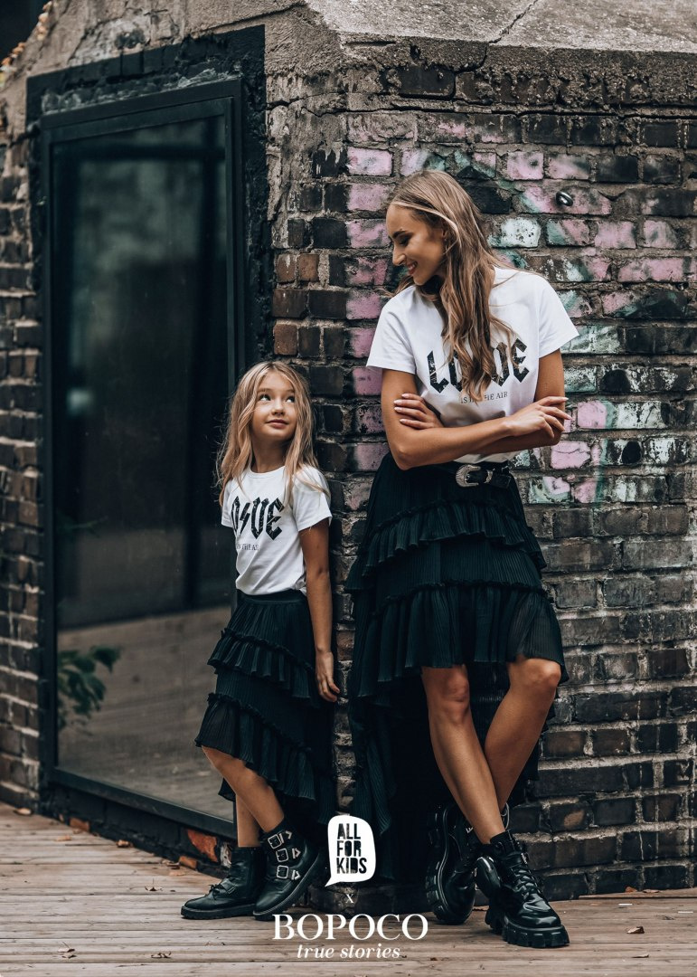 Pleated skirt with flounces and an extended back Pleated skirt with flounces and an extended back