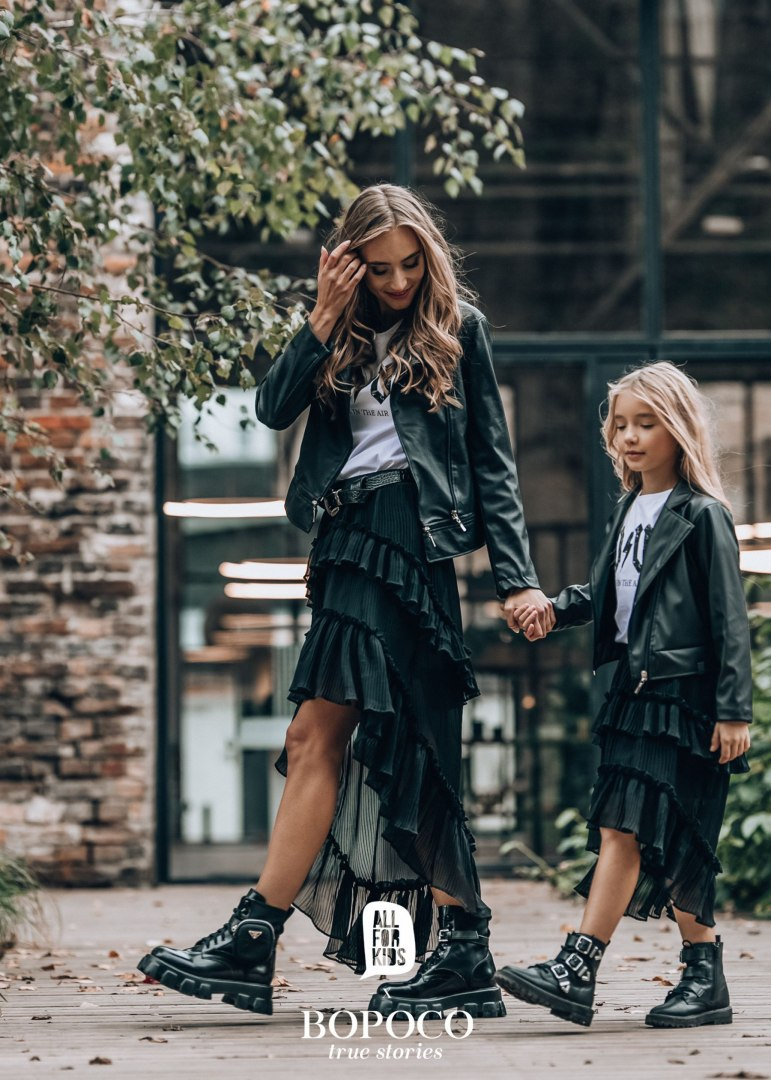 Pleated skirt with flounces and an extended back Pleated skirt with flounces and an extended back
